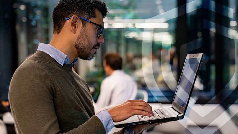 woman looking at her laptop screen wondering how to protect herself from malicious threats